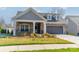 Charming single-Gathering home with a stone and siding facade and a well-manicured lawn at 1005 Headwaters Ct, Matthews, NC 28104