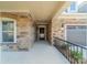 Inviting front porch with stone accents and a covered entryway, offering a warm welcome at 1005 Headwaters Ct, Matthews, NC 28104