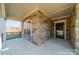 Cozy covered porch with stone detailing, providing a shaded entry and visual appeal at 1005 Headwaters Ct, Matthews, NC 28104