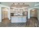 Spacious kitchen featuring an island with pendant lighting, stainless steel appliances, and modern cabinetry at 1005 Headwaters Ct, Matthews, NC 28104