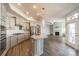 Open-concept kitchen with a granite island, flowing into the living room with a fireplace at 1005 Headwaters Ct, Matthews, NC 28104