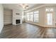 Inviting living room with a fireplace, built-in shelving, and a ceiling fan for added comfort at 1005 Headwaters Ct, Matthews, NC 28104