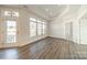 Bright living room with large windows and decorative glass transom above the door at 1005 Headwaters Ct, Matthews, NC 28104
