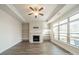 Bright living room featuring a fireplace, built-in shelves, and large windows for natural light at 1005 Headwaters Ct, Matthews, NC 28104