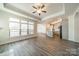 Spacious living room open to the kitchen with modern wood floors and tray ceiling at 1005 Headwaters Ct, Matthews, NC 28104