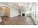 Open living room with fireplace, white shelving, and large windows at 1005 Headwaters Ct, Matthews, NC 28104