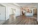 Bright living room open to the kitchen with white walls and wood floors at 1005 Headwaters Ct, Matthews, NC 28104
