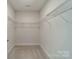Walk-in closet with carpeted floors and wire shelving for organization at 1005 Headwaters Ct, Matthews, NC 28104