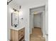 Bathroom with a wooden vanity, sleek mirror, and modern light fixture at 108 Colville Rd # 21B, Charlotte, NC 28207