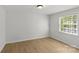 Bright bedroom with hardwood floors and window at 108 Colville Rd # 21B, Charlotte, NC 28207