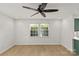 Bright bedroom with hardwood floors, ceiling fan, and large window at 108 Colville Rd # 21B, Charlotte, NC 28207