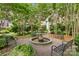 Charming courtyard featuring a fountain, benches, and lush landscaping at 108 Colville Rd # 21B, Charlotte, NC 28207