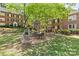 Brick buildings surrounding a courtyard with patio dining set and grill, great for relaxing or entertaining outdoors at 108 Colville Rd # 21B, Charlotte, NC 28207