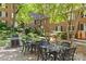 Close-up of a outdoor dining table and chairs in the brick courtyard next to the grill at 108 Colville Rd # 21B, Charlotte, NC 28207