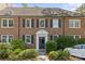 Traditional brick home showcasing an arched doorway, shutters, and mature landscaping at 108 Colville Rd # 21B, Charlotte, NC 28207