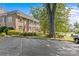 Brick building showing accessible parking with well-kept landscaping and mature trees in a park-like setting at 108 Colville Rd # 21B, Charlotte, NC 28207