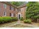 Brick exterior of the home with black shutters and neatly trimmed landscaping at 108 Colville Rd # 21B, Charlotte, NC 28207