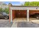 A peek at the brick carport featuring two parking spaces at 108 Colville Rd # 21B, Charlotte, NC 28207