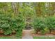 A beautiful courtyard garden with a stone fountain and shade trees at 108 Colville Rd # 21B, Charlotte, NC 28207