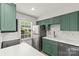 Bright kitchen with green cabinets, stainless steel appliances, and subway tile backsplash at 108 Colville Rd # 21B, Charlotte, NC 28207