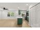 Open living room with a kitchen, featuring green cabinetry, a white island, and ample natural light at 108 Colville Rd # 21B, Charlotte, NC 28207