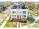 Aerial view of modern townhome showcasing rooftop patio, colorful door, and manicured landscaping at 111 W Poindexter Dr, Charlotte, NC 28203