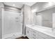 Bathroom showcasing a glass-enclosed shower with white subway tile, double vanity, and modern finishes at 111 W Poindexter Dr, Charlotte, NC 28203