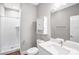 Clean bathroom featuring a white vanity, toilet, tiled shower, and modern fixtures at 111 W Poindexter Dr, Charlotte, NC 28203