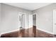 Spacious bedroom with hardwood floors, neutral paint, and access to an ensuite bathroom at 111 W Poindexter Dr, Charlotte, NC 28203