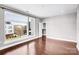 Bright bedroom with large windows offering views and hardwood floors leading to a closet at 111 W Poindexter Dr, Charlotte, NC 28203