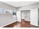 Bright, minimalist bedroom with hardwood floors, white walls, and a view of the outdoors at 111 W Poindexter Dr, Charlotte, NC 28203