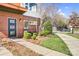 Close up of a brick clad modern townhome with small garden and well maintained sidewalk at 111 W Poindexter Dr, Charlotte, NC 28203