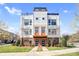 Contemporary townhome facade featuring clean lines, brick accents, and a well-manicured lawn at 111 W Poindexter Dr, Charlotte, NC 28203