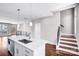 Open-concept kitchen with an island, stainless steel appliances, and modern pendant lighting at 111 W Poindexter Dr, Charlotte, NC 28203