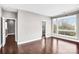 Open-concept living area with hardwood floors and a door leading to another room at 111 W Poindexter Dr, Charlotte, NC 28203