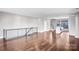 Open concept living space with hardwood flooring, modern railing, and natural light at 111 W Poindexter Dr, Charlotte, NC 28203
