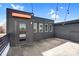 Outdoor rooftop deck featuring string lights, a building with a door, and ample space for entertainment at 111 W Poindexter Dr, Charlotte, NC 28203