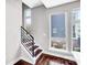 Stylish staircase featuring dark wood treads, white risers, and a modern black railing at 111 W Poindexter Dr, Charlotte, NC 28203