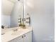 Powder room with vanity, mirror, modern fixtures, and neutral paint at 1224 Green Oaks Ln # I, Charlotte, NC 28205