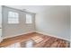 Bright bedroom with hardwood floors featuring two windows that bring in natural light at 1224 Green Oaks Ln # I, Charlotte, NC 28205
