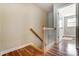 Bright hallway features wood flooring, wooden banister, and white trim, providing a clean transitional space at 1224 Green Oaks Ln # I, Charlotte, NC 28205