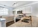 Well-lit kitchen featuring stainless steel appliances, granite countertops, and white cabinetry, offering modern convenience at 1224 Green Oaks Ln # I, Charlotte, NC 28205
