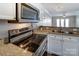 Well-lit kitchen featuring granite counters, stainless steel appliances, and white cabinetry at 1224 Green Oaks Ln # I, Charlotte, NC 28205