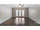 Living room filled with natural light, hard surface floors and ceiling fan at 1224 Green Oaks Ln # I, Charlotte, NC 28205
