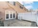 Fenced patio with double doors provides private outdoor access and features brick accents at 1224 Green Oaks Ln # I, Charlotte, NC 28205