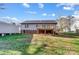 The home features a lawn, mature trees and an elevated deck with a brick foundation at 124 Washington St, York, SC 29745