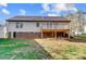 The home features a lawn, mature trees and an elevated deck with a brick foundation at 124 Washington St, York, SC 29745