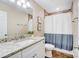 Bathroom with granite countertop, white vanity, and a shower with a white and gray curtain at 124 Washington St, York, SC 29745