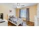 Cozy bedroom with a wood floor, ceiling fan, and a single bed featuring fun video game themed bedding at 124 Washington St, York, SC 29745