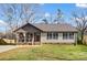 Inviting home featuring a covered porch with seating and a well-maintained front yard at 124 Washington St, York, SC 29745